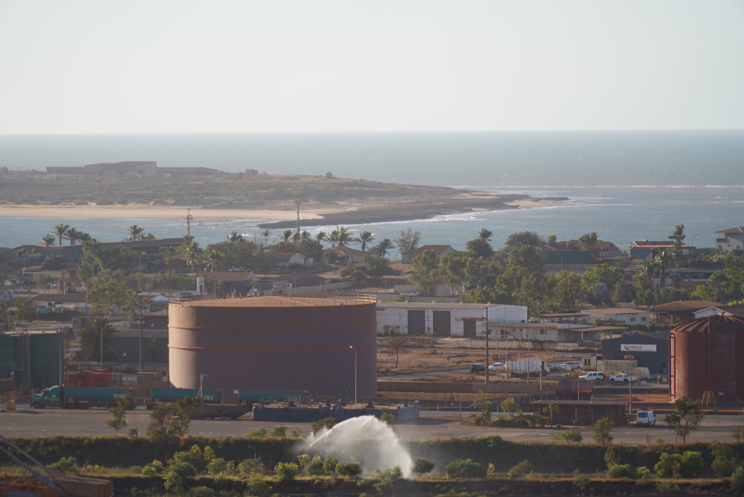 Aerial view across Port Hedland operations, rail sidings, port and the ocean beyond